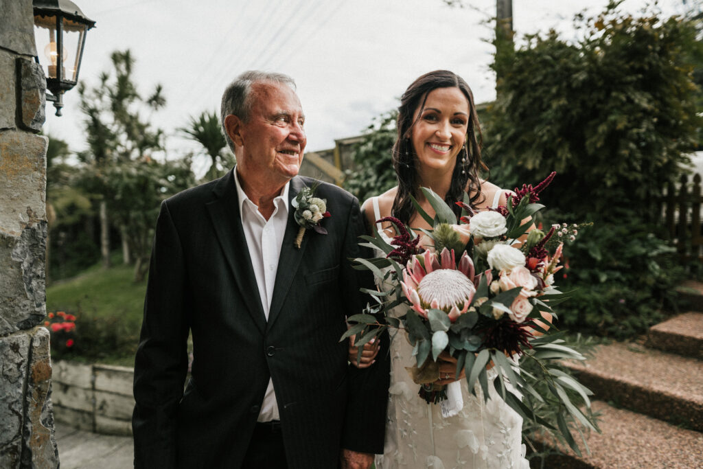 bride with her father prior to walking down the aisle in a Browns Bay home