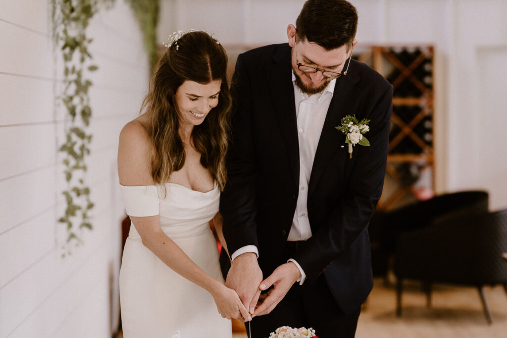 bride and groom cutting their cake at their wedding