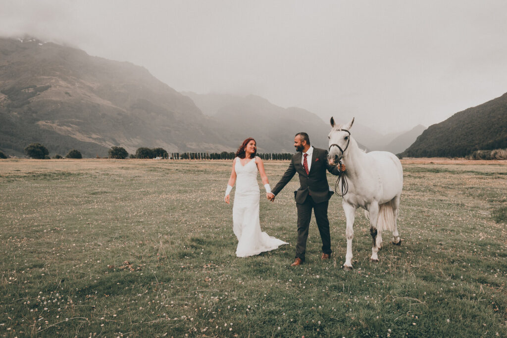 Queenstown re-shoot of wedding photos with a horse, set in glenorchy with mountains and mist in the background